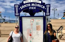 Women at Santa Monica Pier Sign