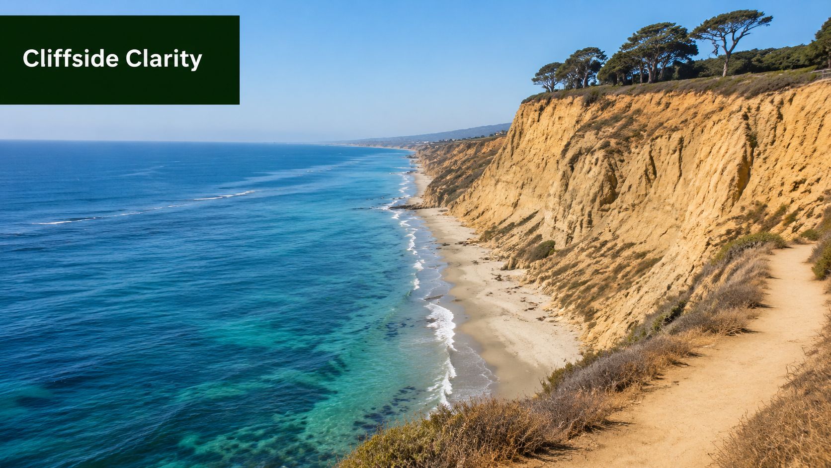 A scenic view of sandy clear water beaches in California with towering cliffs and Pacific ocean views.