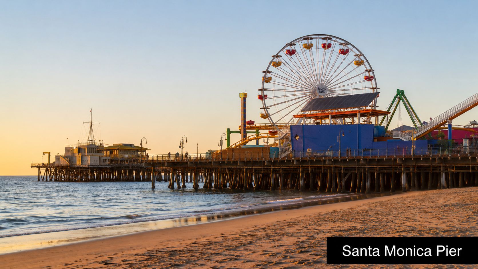 A scenic view of the Santa Monica Pier at sunset with the Ferris wheel over the ocean