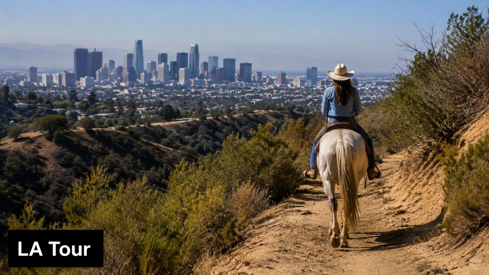 A person wearing a cowboy hat riding a white horse on a scenic trail overlooking Los Angeles.