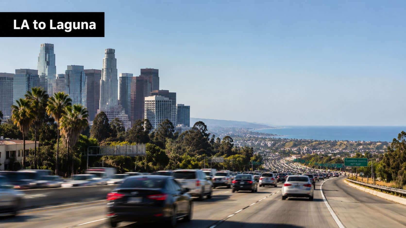 A view of the Los Angeles skyline with highway traffic heading towards the Pacific Ocean coastline.