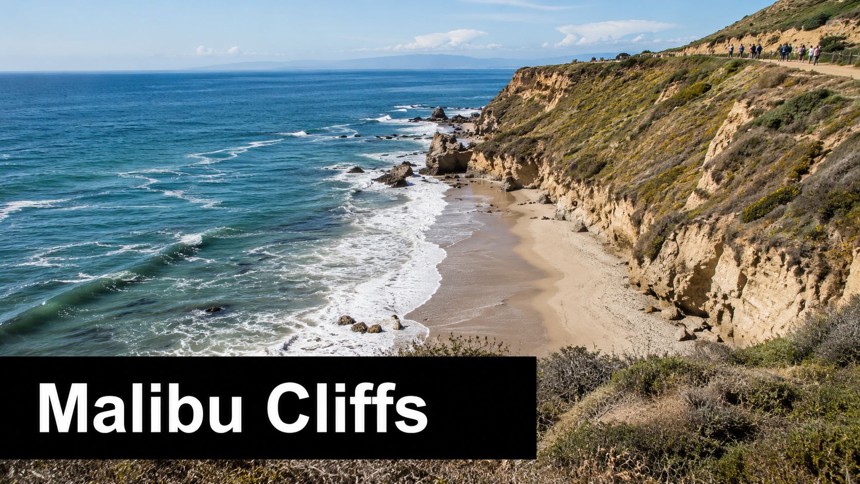 A scenic coastal view of the sandy beach and high cliffs in Malibu, Southern California.