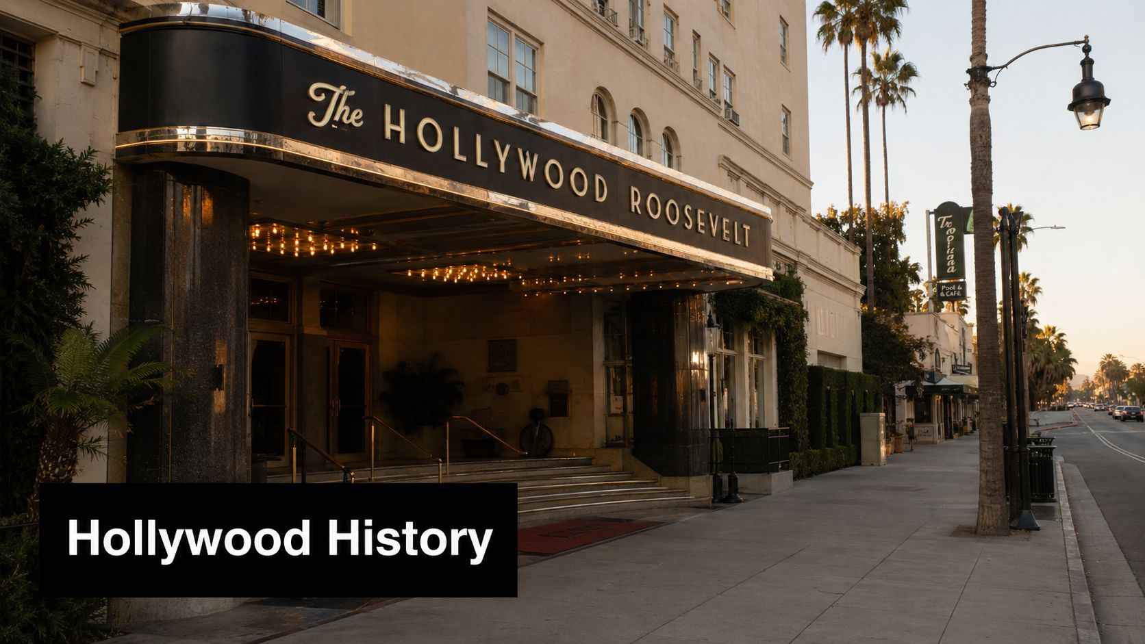 The historic Hollywood Roosevelt hotel facade at sunset featuring a glowing marquee on a city street.